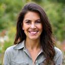 Portrait of Sarah Miller, a warm and approachable woman, possibly in a community garden.